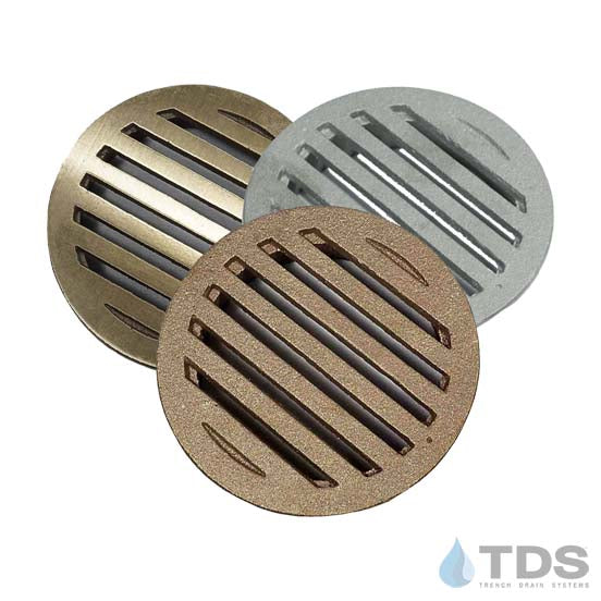 Three 4" round drain covers in brushed bronze, aluminum and natural bronze with slot pattern